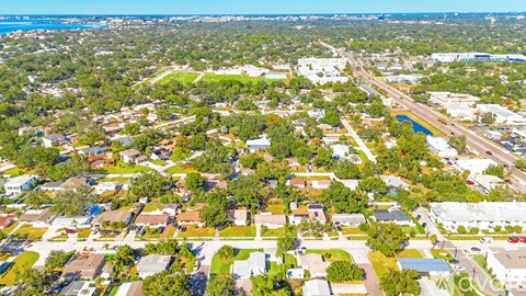A bird's eye view of a residential area with houses and roads.