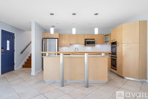 A kitchen with wooden cabinets and a central island.