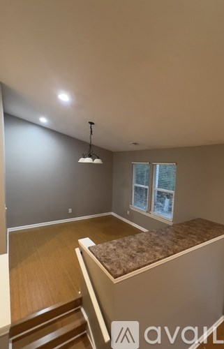 A room with a window and a bed.