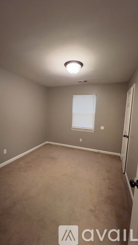 A room with a window and a door.