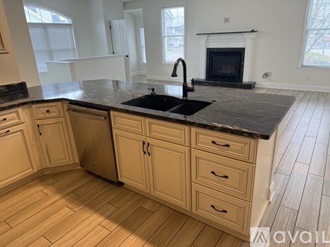 A kitchen with wooden cabinets and a black countertop.