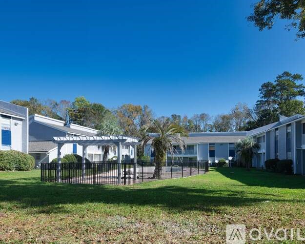 A row of houses with a clear blue sky above them.