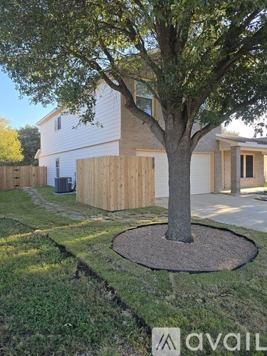 A house with a tree in front of it.