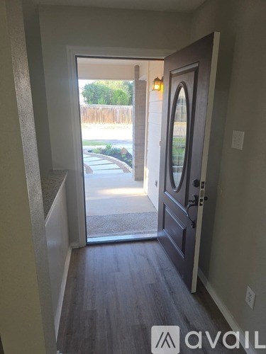 A hallway with a marble countertop and a door on the right.
