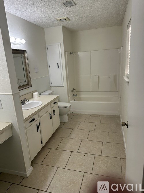 A bathroom with a toilet, sink, and bathtub.