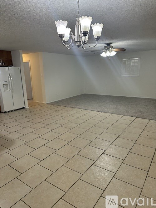 A room with a chandelier and a ceiling fan.