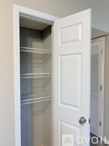 A white door with a handle and a small window on the left side.