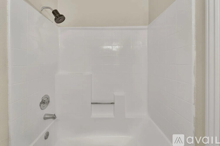 A white bathroom with a shower and a door.