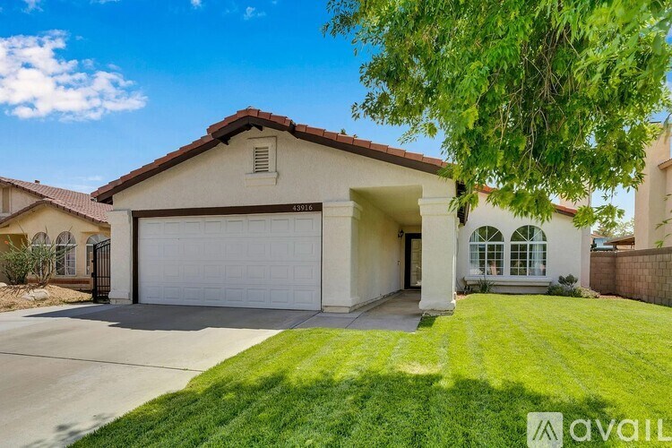 A house with a garage and a driveway is for sale.