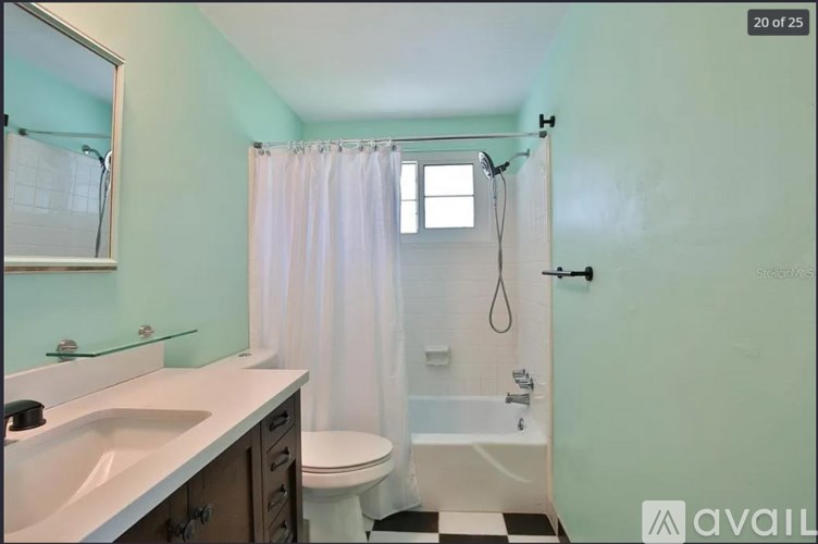 A bathroom with a white sink, toilet, and bathtub.