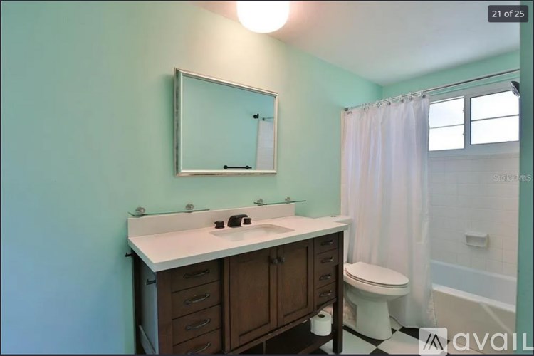 A bathroom with a white countertop and a white sink.