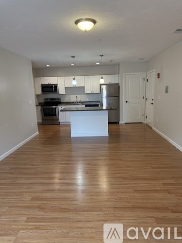 A kitchen with a white island in the middle of the room.