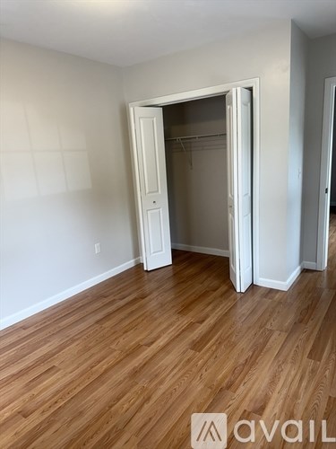 A room with wooden floors and a white door.