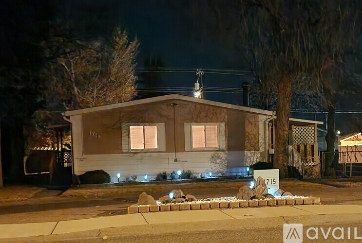 A house numbered 1715 is shown at night.