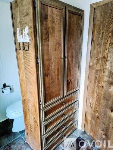 A wooden cabinet with a white sign on it.