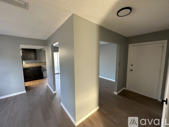 A room with a wooden floor and a white door.