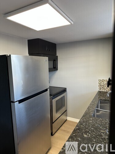 A kitchen with a stainless steel refrigerator and oven.