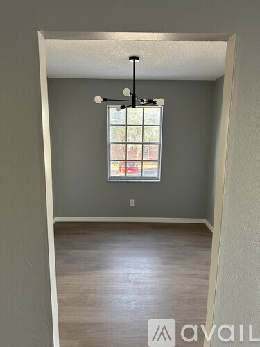 A room with a window and a light fixture.