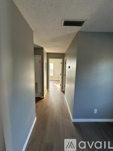 A long hallway with a door at the end.