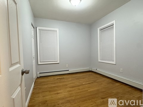 A room with wooden floors and white walls.