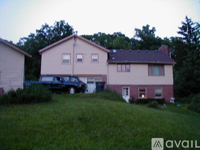 A house with a car parked in front of it.
