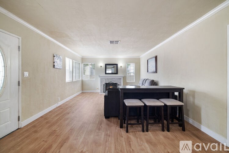 A room with a piano and stools.