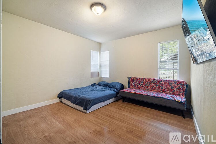A bedroom with a bed and a couch.