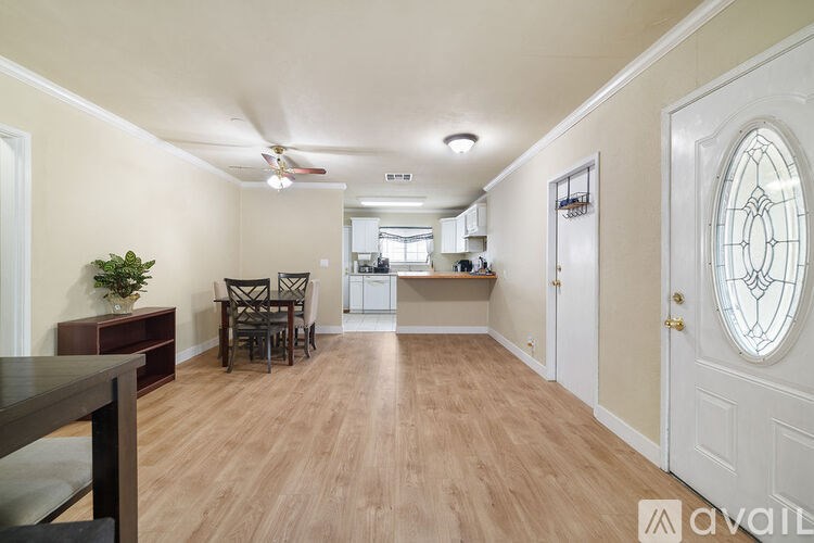 A dining room with a wooden table and chairs.