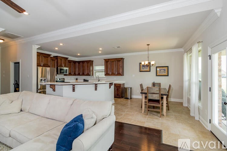 A living room with a white couch and wooden cabinets.