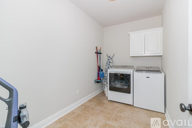 A kitchen area with a white cabinet and a white oven.