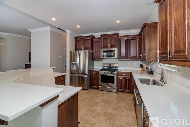 A kitchen with brown cabinets and a white countertop.