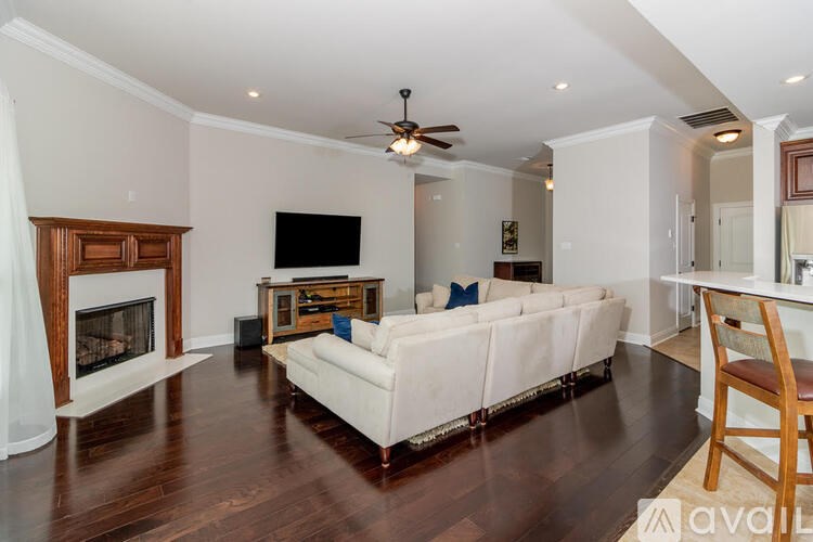 A living room with a white couch and a fireplace.
