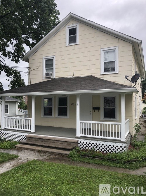 A two-story house with a front porch.