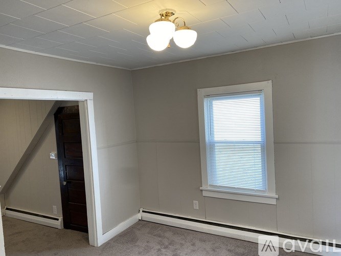 A room with a window and a door.