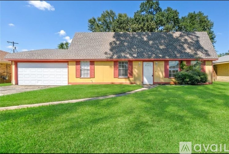A house with a red and yellow exterior and a grey roof.