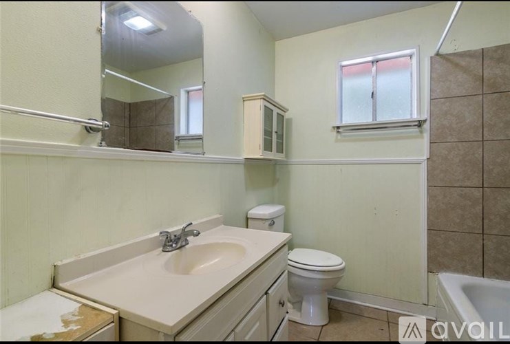 A bathroom with a sink, toilet, and bathtub.
