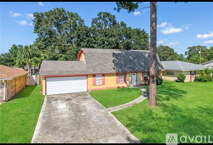 A house with a red roof and a garage door is for sale.