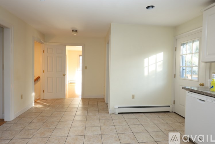 A kitchen area with a dishwasher and a window.
