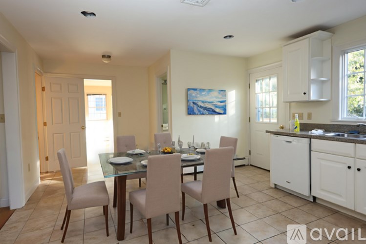 A dining room with a glass table and chairs.