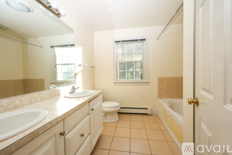 A bathroom with a toilet, sink, and bathtub.