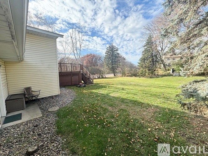 A backyard with a gravel path leading to a house.