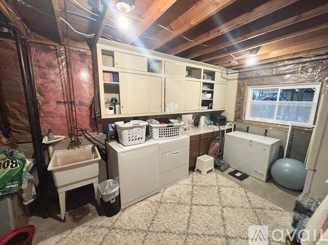 A room with a lot of storage cabinets and a window.