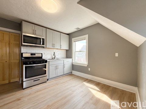 A kitchen with wooden cabinets and a stainless steel oven.