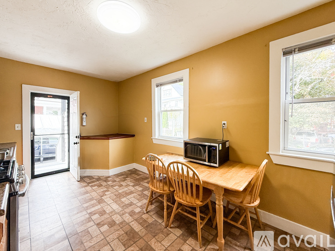 A kitchen with a table and chairs in it.