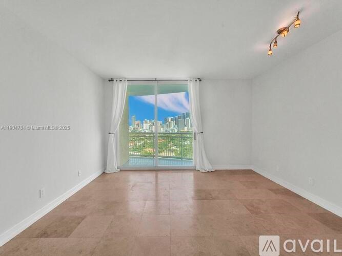 A spacious room with a view of the city through the window.