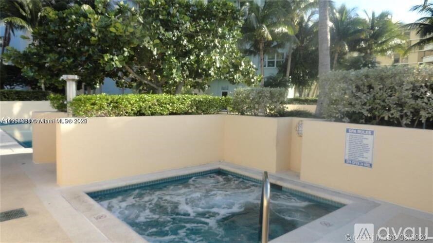 A hot tub sits in the middle of a landscaped area.