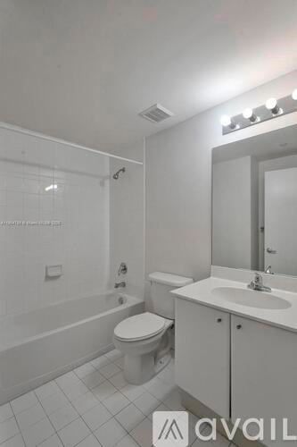 A bathroom with a toilet, sink, and shower.