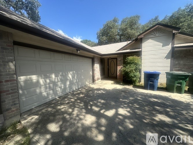 A house with a garage door and a driveway.