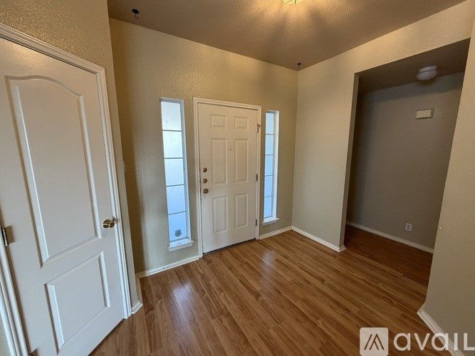 A room with wooden floors and white doors.