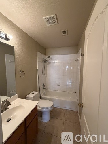 A bathroom with a toilet, sink, and shower.